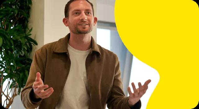 A photo of a Trustpilot employee speaking at a meeting