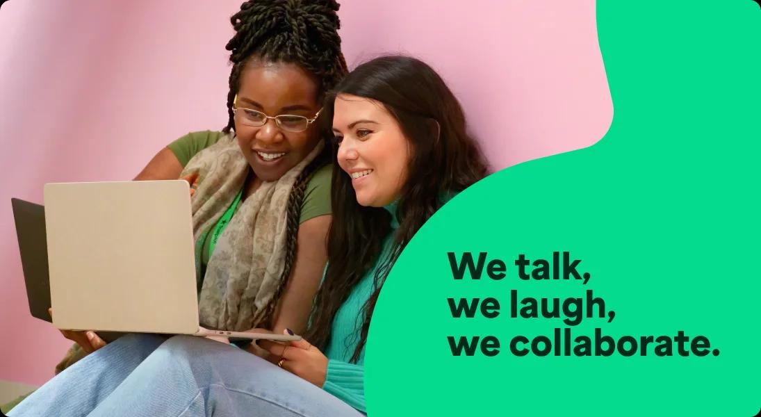 A photo of two women working together on a laptop with an overlay of text that says We talk, we laugh, we collaborate.